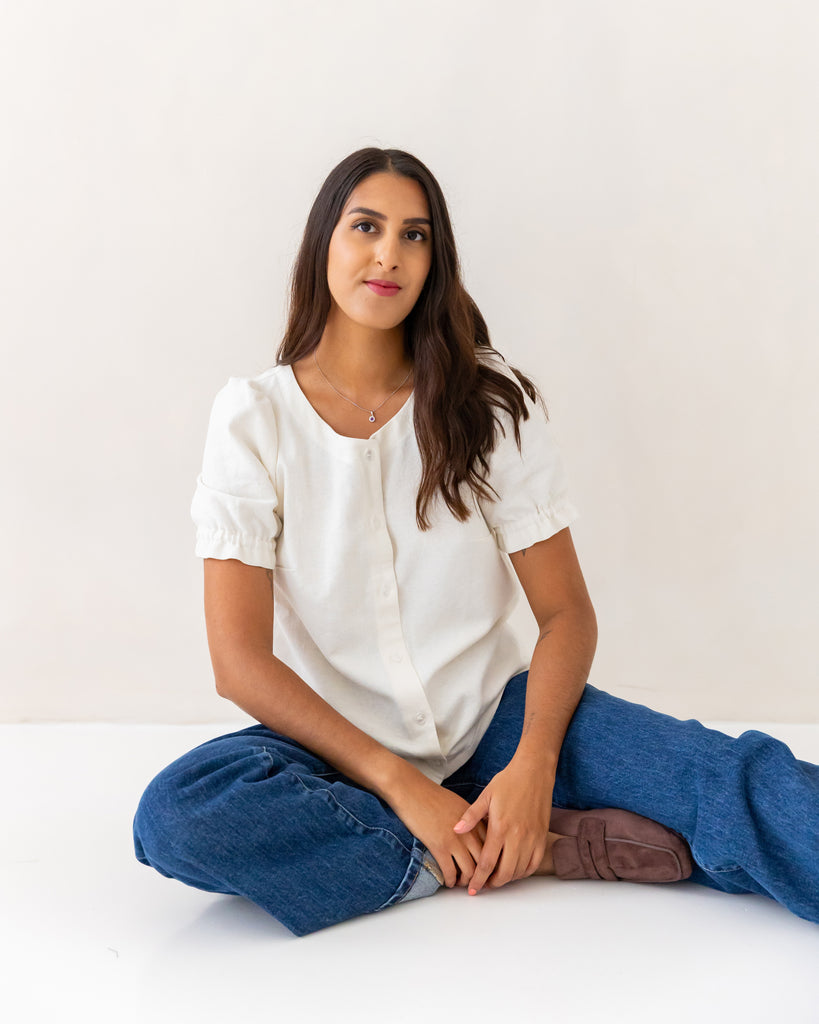 Faye Blouse sewing pattern, short sleeve variation model sitting on the floor